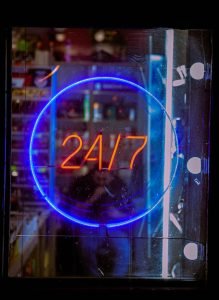 image containing neon sign of 24/7 service